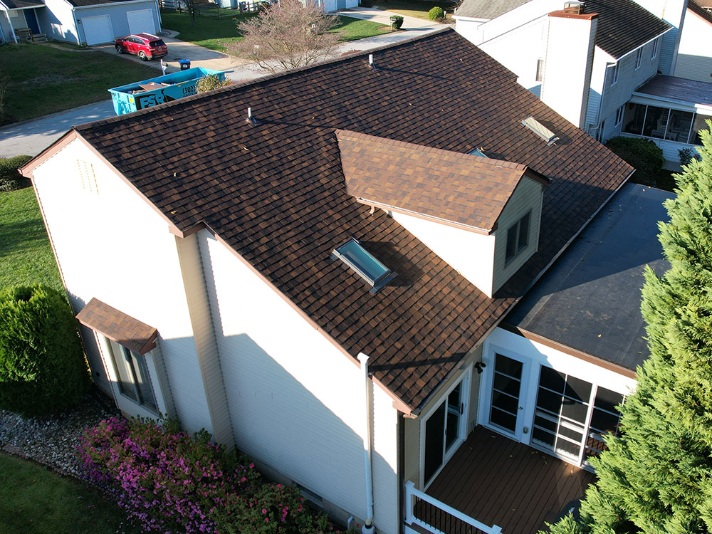 An upper side view of a residential house with a new roof