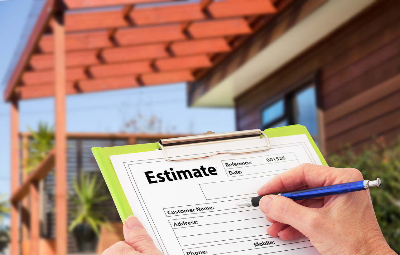 A roofing contractor fills out an estimate form for a roof installation project.
