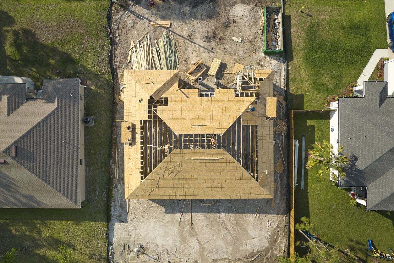 A bird’s eye view of a new roof being installed on a home.